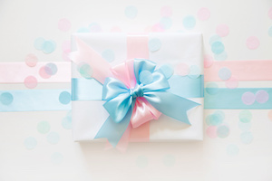 A gift for a boy and a girl at the same time. Surprise. Satin ribbon in blue and pink.